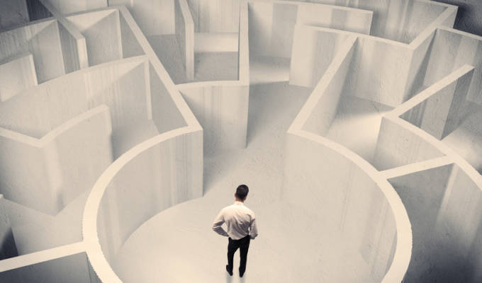 Business person standing in maze center